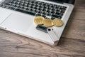 Hardware cryptocurrency wallet with golden Bitcoin BTC on computer. Safe storage for crypto