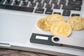 Hardware cryptocurrency wallet with golden Bitcoin BTC on computer. Safe storage for crypto