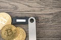 Hardware cryptocurrency wallet with golden Bitcoin BTC. Safe storage for crypto