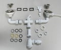 Hardware elements and tubes for a kitchen sink drain Royalty Free Stock Photo