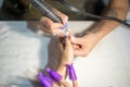 Hardware manicure. Removal of old gel varnish in the salon. Manicure master doing beauty procedure for client, closeup and top vie Royalty Free Stock Photo