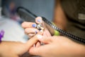 Hardware manicure. Removal of old gel varnish in the salon. Manicure master doing beauty procedure for client, closeup and top vie Royalty Free Stock Photo