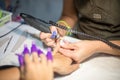 Hardware manicure. Removal of old gel varnish in the salon. Manicure master doing beauty procedure for client, closeup and top vie Royalty Free Stock Photo