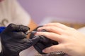 Hardware Manicure using electric device machine. procedure for the preparation of nails before applying nail polish. Hands of Royalty Free Stock Photo