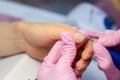 Hardware Manicure using electric device machine. procedure for the preparation of nails before applying nail polish. Hands of Royalty Free Stock Photo