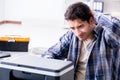 The hardware repairman repairing broken printer fax machine Royalty Free Stock Photo