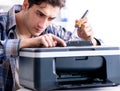 Hardware repairman repairing broken printer fax machine