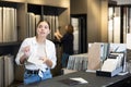 in hardware store,woman chooses ceramic tile with modern pattern for bathroom Royalty Free Stock Photo