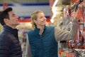 Hardware store worker assisting customer