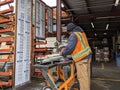 Woodinville, WA USA - circa March 2021: Hardware store worker cutting PVC pipe with a buzz saw in the lumber yard at a McLendon