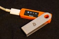 Hardware wallet displaying Bitcoin on dark surface indoors Royalty Free Stock Photo