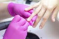 manicurist in pink gloves manicures a girl Royalty Free Stock Photo