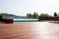 Hardwood decking around the Infinity swimming pool with safe fence overlooking nature