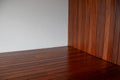 Hardwood flooring, indoor ipe wood floor and cladding with white wall corner empty space Royalty Free Stock Photo