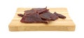 Hardwood smoked beef jerky on a cutting board Royalty Free Stock Photo