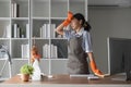 A hardworking Asian woman puts rubber gloves and cleaning equipment on her forehead. shows fatigue from Clean the office Royalty Free Stock Photo
