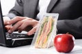 Hardworking businessman with uneaten lunch Royalty Free Stock Photo