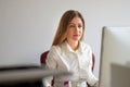 Hardworking businesswoman concentrating on her work as she sits at a computer