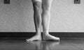 The hardworking disciplined ballerina ballet dancer warming up in her pointe shoes and bare feet, displaying the behind the scenes Royalty Free Stock Photo