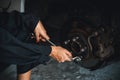 Hardworking female mechanic changing car wheel in auto repair workshop. Oxus