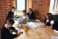 Hardworking little business people working in the office, preparing presentation Royalty Free Stock Photo