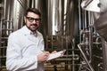 Hardworking man making notes at beer factory Royalty Free Stock Photo