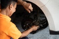 Hardworking mechanic changing car wheel in auto repair workshop. Oxus