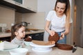 Hardworking woman and her child making tasty cake for her husband Royalty Free Stock Photo
