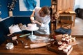 Hardworking young woman enjoying decorating cake Royalty Free Stock Photo