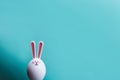 Hare on a blue background. Minimal Easter concept