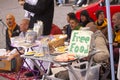 Hare Krishna members singing and playing in the street with sign offering free food.