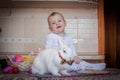 The hare is snow-white beautiful and fluffy. Easter bunny on the table. with a cute little baby