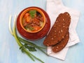 Hare wild rabbit with vegetables Goulash in Copper Pot on blue Wooden table, roasted beef meat with carrot, leek, onion in round c Royalty Free Stock Photo