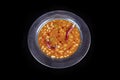 Haricot bean. Dried beans,white beans in tomato sauce in a copper bowl dry chili pepper on the plate Royalty Free Stock Photo