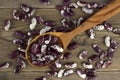 Haricot beans in a wooden spoon on wooden background Royalty Free Stock Photo