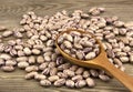 Haricot beans in a wooden spoon on wooden background Royalty Free Stock Photo