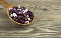 Haricot beans in a wooden spoon on wooden background Royalty Free Stock Photo