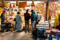 Street market vendor sells jewelry and other goods to customers at night