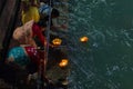 Haridwar, India - March 20, 2017: Holy ghats at Haridwar, India, sacred town for Hindu religion. Pilgrims offering floating flowe Royalty Free Stock Photo