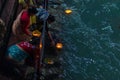 Haridwar, India - March 20, 2017: Holy ghats at Haridwar, India, sacred town for Hindu religion. Pilgrims offering floating flowe Royalty Free Stock Photo