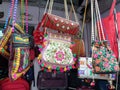 Haridwar, Uttarakhand, India - 01 04 2021: Indian multicolored handmade embroidered handbags hanging in the market