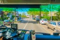 Harlem, Amsterdam, Netherlands - July 14, 2015: Inside public transportation bus in traffic, front seat view, driver on