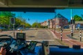 Harlem, Amsterdam, Netherlands - July 14, 2015: Inside public transportation bus in traffic, front seat view, driver on