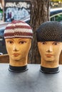 Mannequins wearing kufi skull caps on the street in Harlem