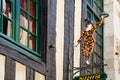 Harlequin street sign of pizzeria in Vitre town