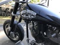 Harley Davidson black motorcycle with pirat scull and crossbones painted on the fuel tank. Part in trade war between USA and Europ