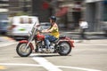 Harley Davidson driver cruises through the streets of San Francisco with typical small helmet