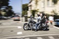 Harley Davidson driver cruises through the streets of San Francisco with typical small helmet