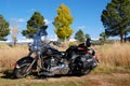 Harley Davidson motorcycle with snow covered mountains in fall