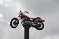 A Harley Davidson Motorcycle on top of a pole